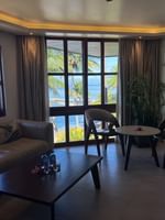 Suite with couch, table, chairs, and ocean view at Warwick Fiji Resort and Spa in Korolevu.