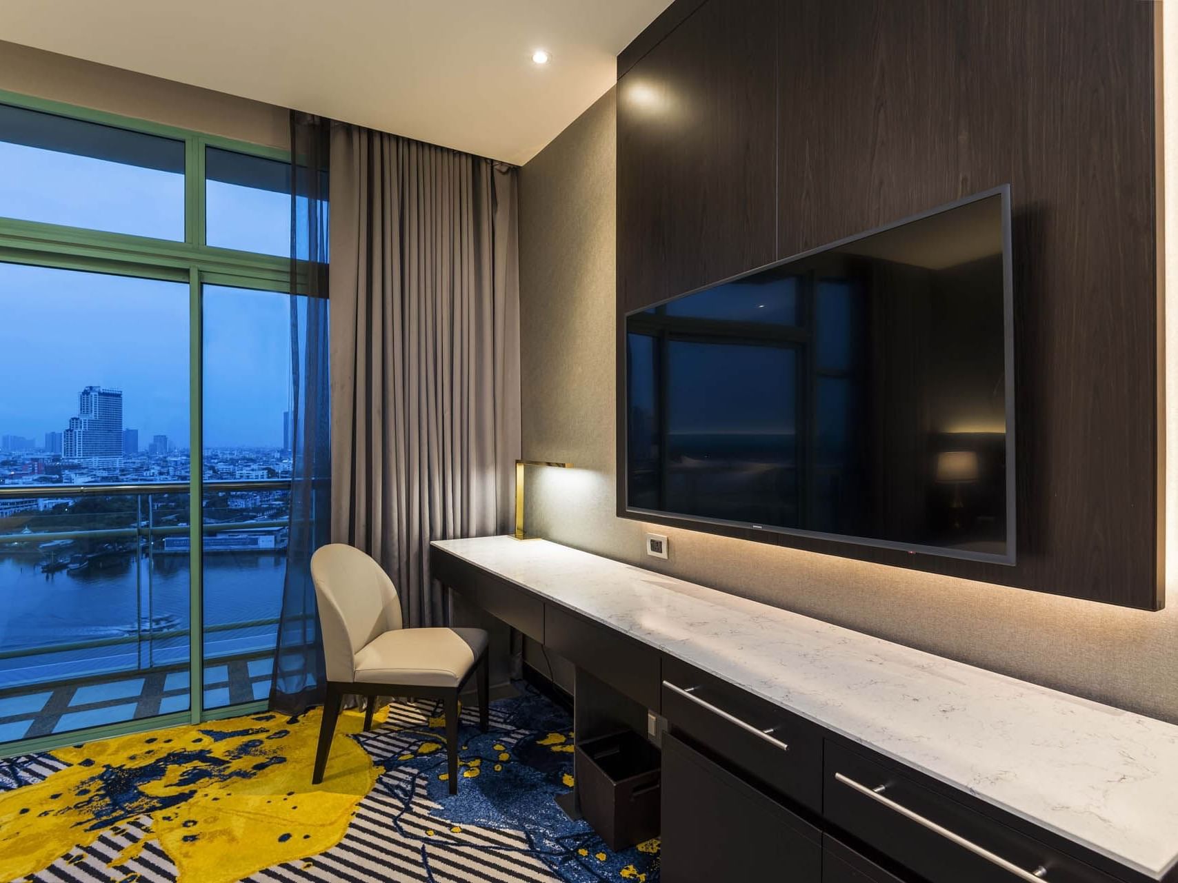 TV & work desk in Grand Deluxe River View at Chatrium Hotels