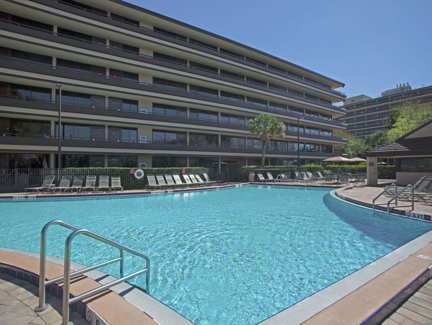 Sunbeds by the outdoor pool at Rosen Inn at Pointe Orlando