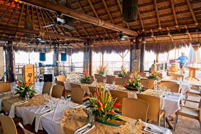 The wedding reception area arranged with tables and chairs for guests in Don Juancho at Hotel Isla Del Encanto
