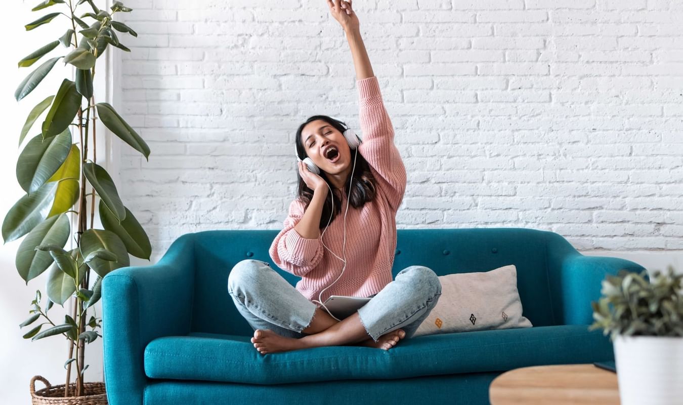 Lady listening to music on a lounge at The Originals Hotels