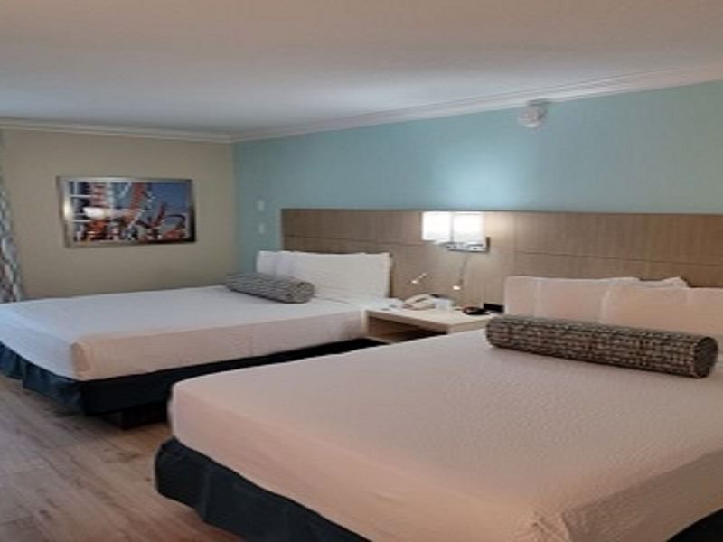 Bedroom in Double Queen Room at Galleria Palms Hotel