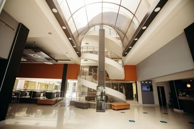 Lobby area with a spiral staircase at Araiza Hermosillo