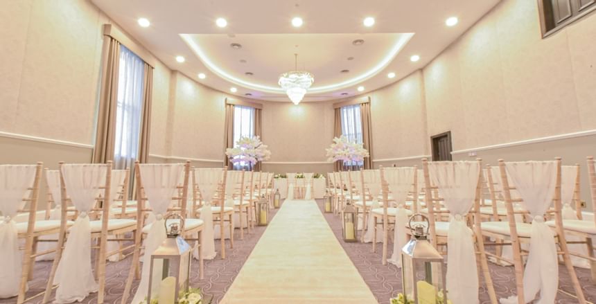 Table & chairs arranged for a wedding in ballroom at Villiers