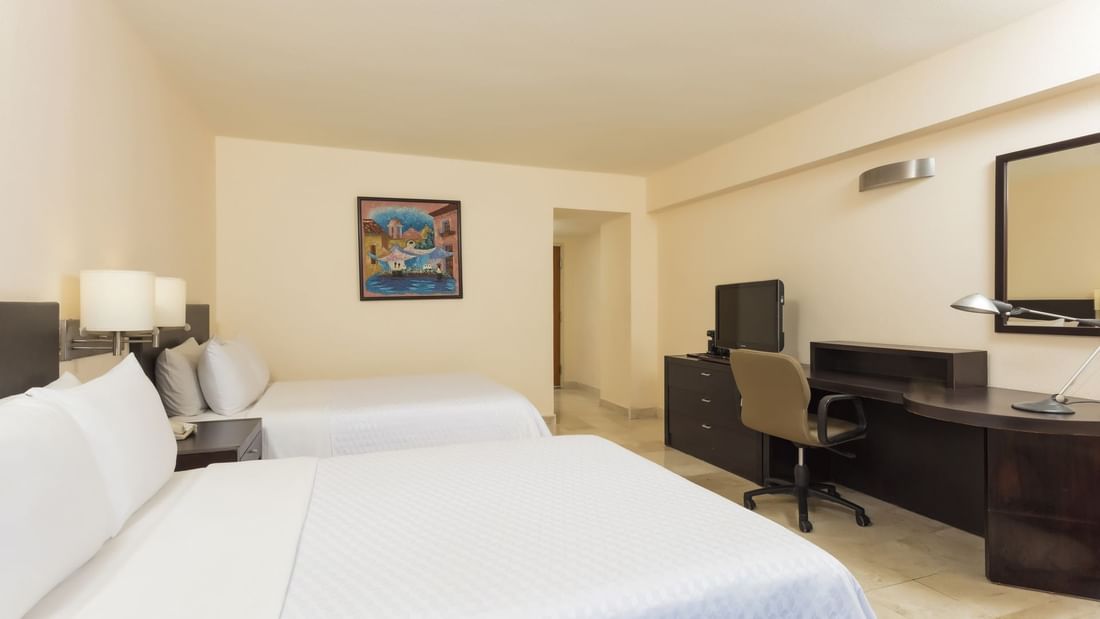 2 Double beds in Deluxe Room with working desk at Fiesta Inn