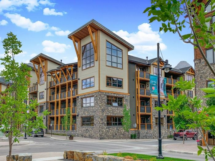 White Spruce Lodge with wood and stone exterior surrounded by greenery at Spring Creek Vacations