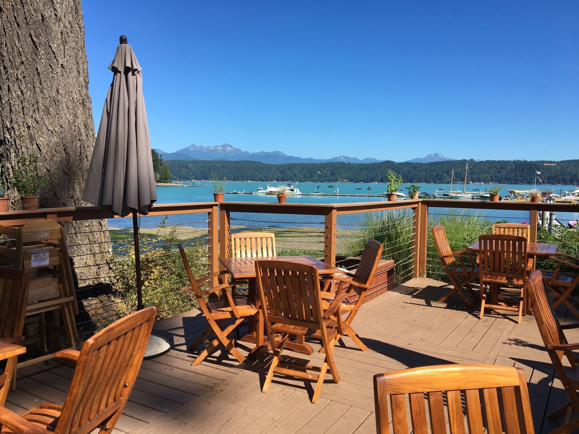 Patio arranged with wooden chairs and tables at Alderbrook Resort & Spa