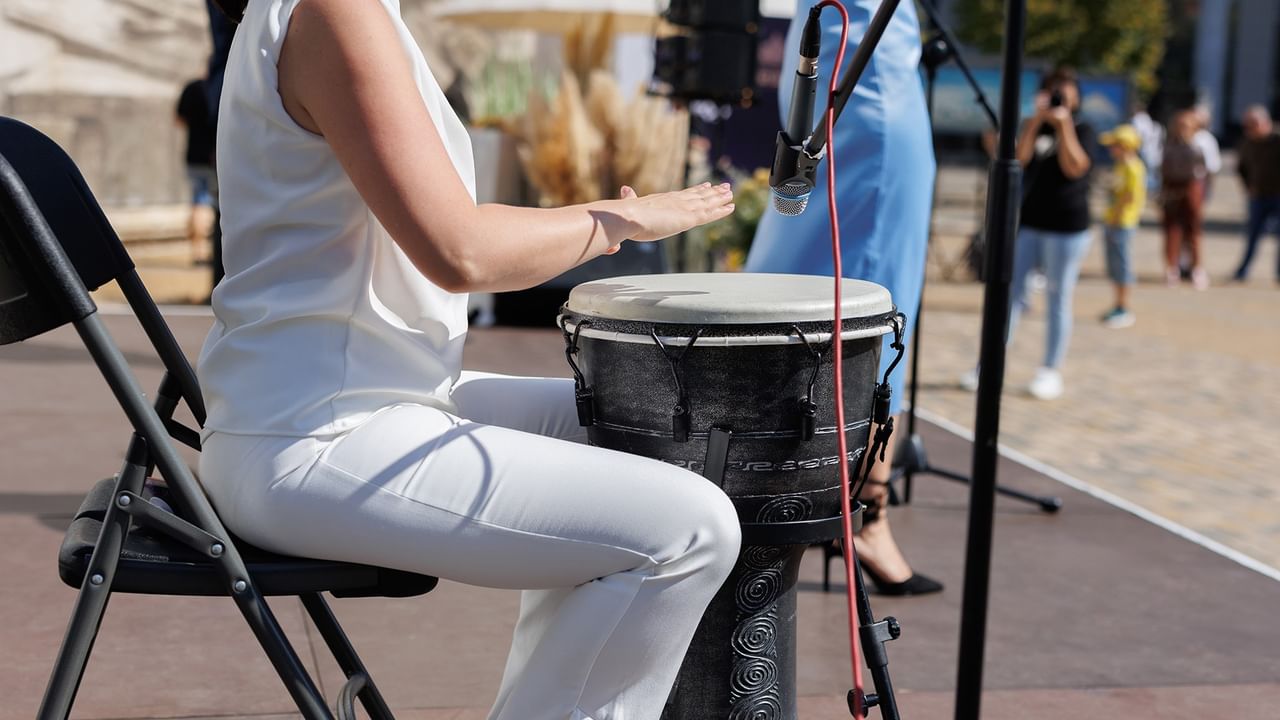 woman hitting drum with her hand