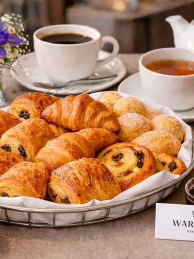 Breakfast spread with croissants, coffee & tea, and juice at Warwick New York