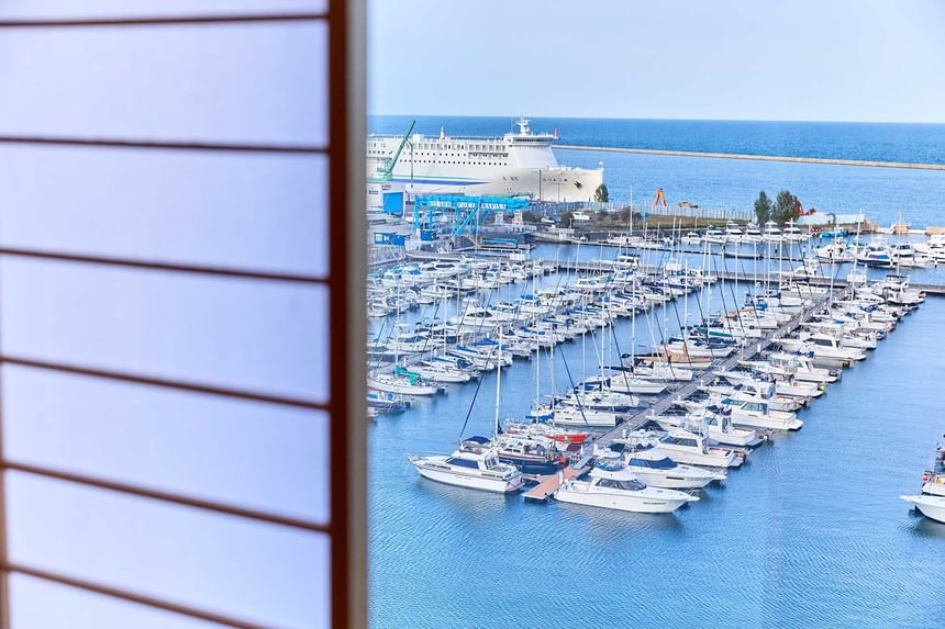 Otaru port Marina view with boats and a cruise ship through a window at Grand Park Otaru