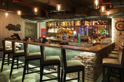 Mot Hai Bar with liquor bottles and glasses at Eastin Grand Hotel Saigon