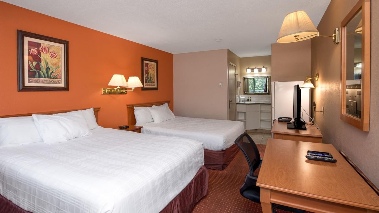 Guest room at Coast Red Deer Hotel with two queen beds and work desk