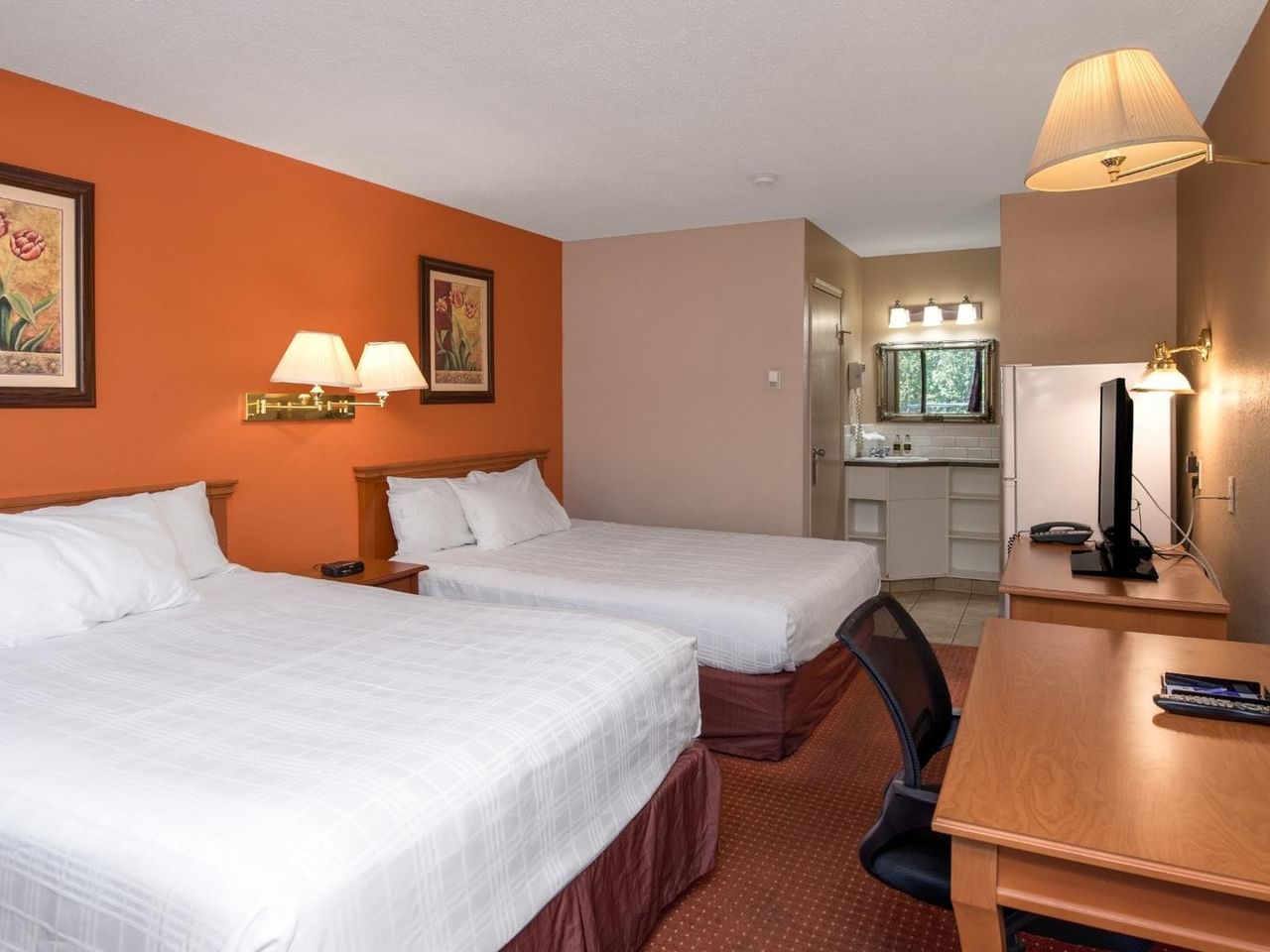 Guest room at Coast Red Deer Hotel with two queen beds and work desk