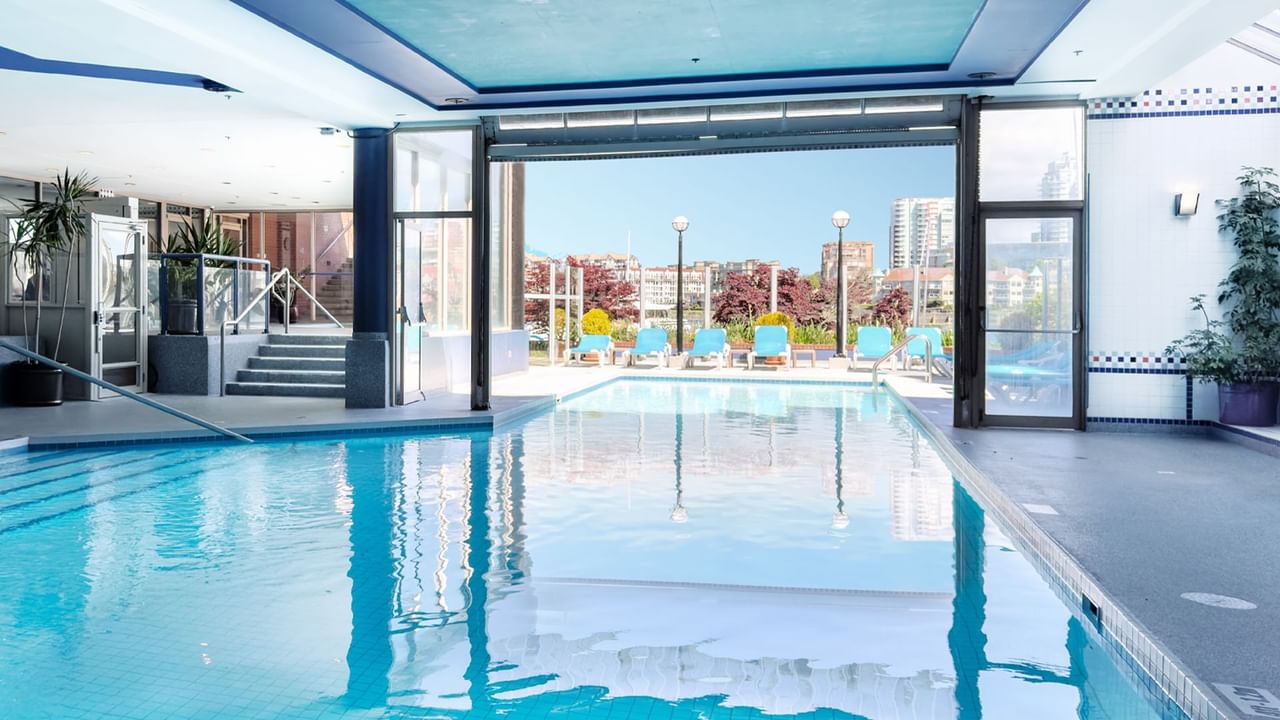 Indoor pool that leads to outside with view of water