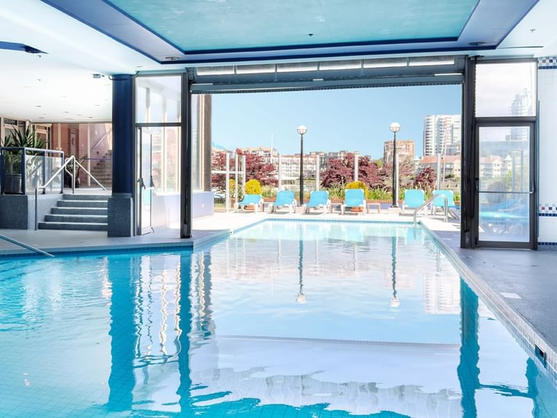 Indoor pool that leads to outside with view of water