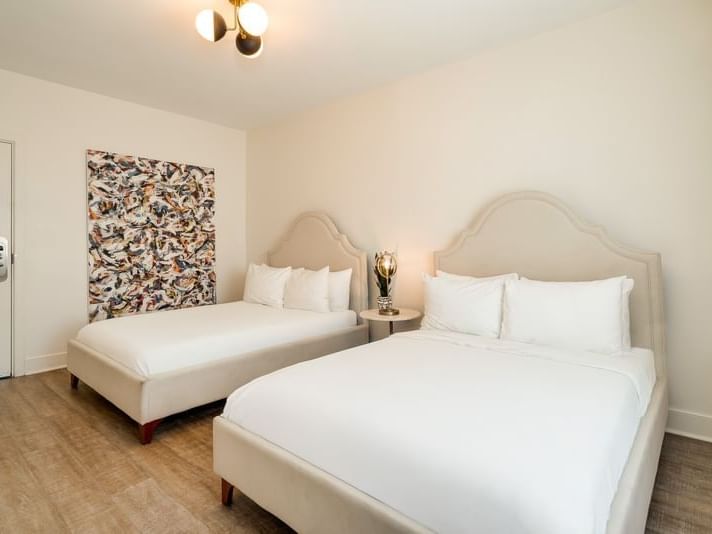 Bedroom Double with two comfy double beds with headboards, abstract art, and wood floors at Kenmore Village Hotel South Beach