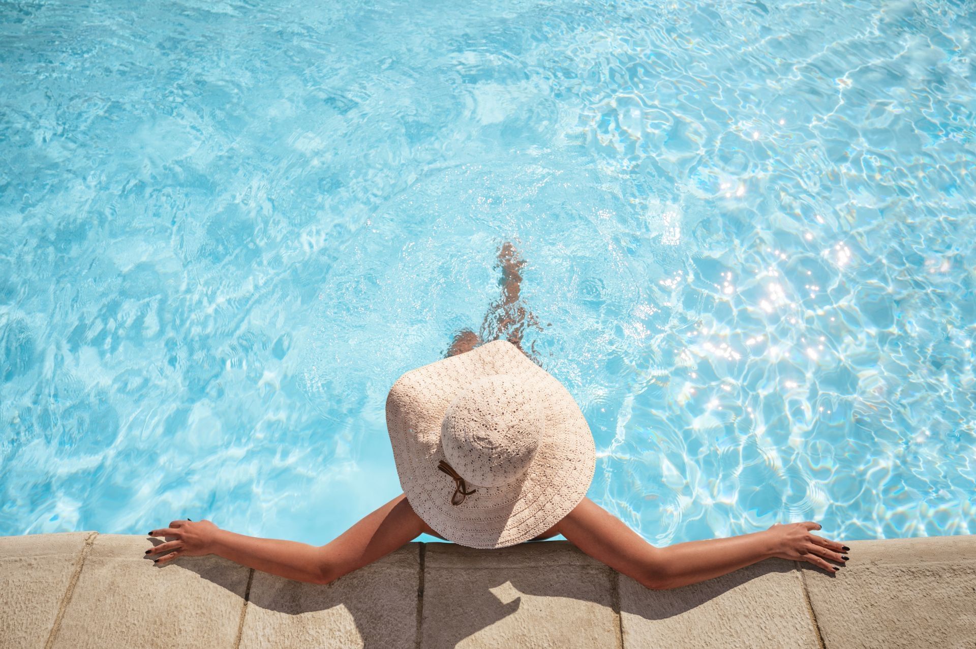 A lady relaxing in a pool at Sunseeker Resort