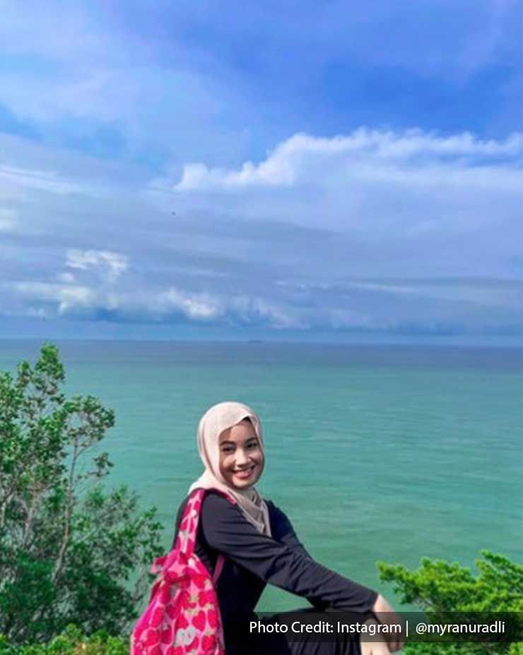 A woman is sitting with a view on Port Dickson sea