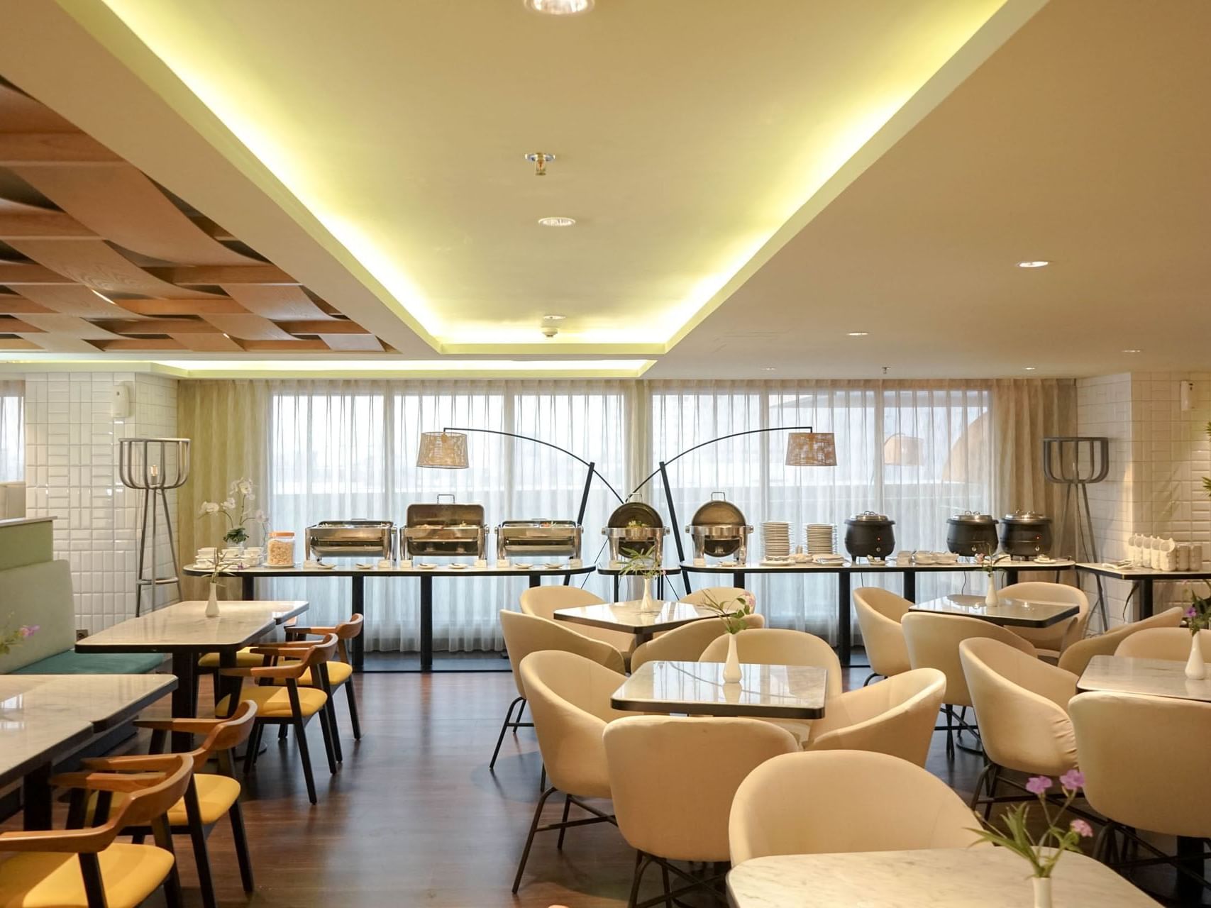 Dining tables and buffet area in Gastro Restaurant at LK Pemuda Semarang Hotel & Residences