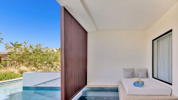 Bed by the indoor pool and outdoor pool in Aqua Swim-Up Pool View room at Live Aqua Punta Cana