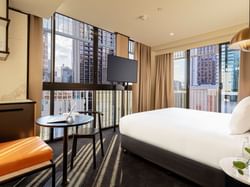 TV facing the bed in Family Room with a city view at Brady Hotels Jones Lane