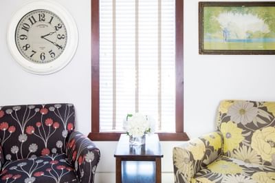 Two armchairs by a window in Apartment 406 at Retro Suites Hotel