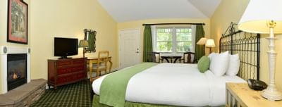 King bedroom with TV and fireplace