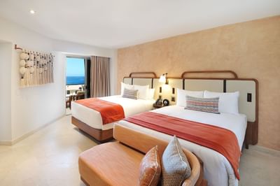 Bedroom with two queen beds at Cabo Villas Beach Resort