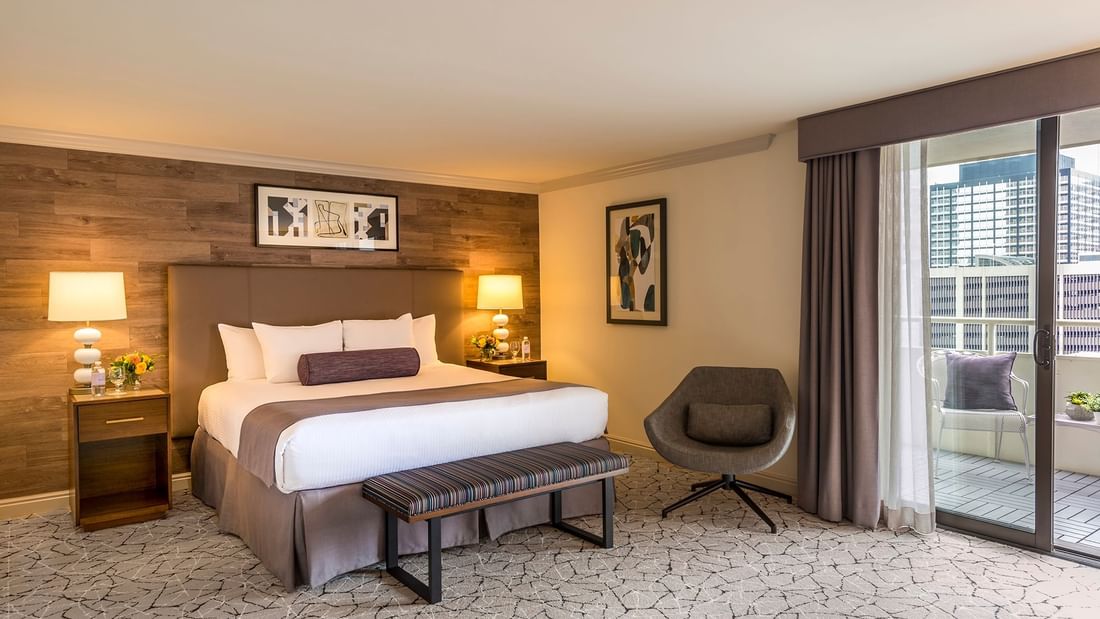 Comfy bed with side tables and chair in Classic Room at Warwick Denver