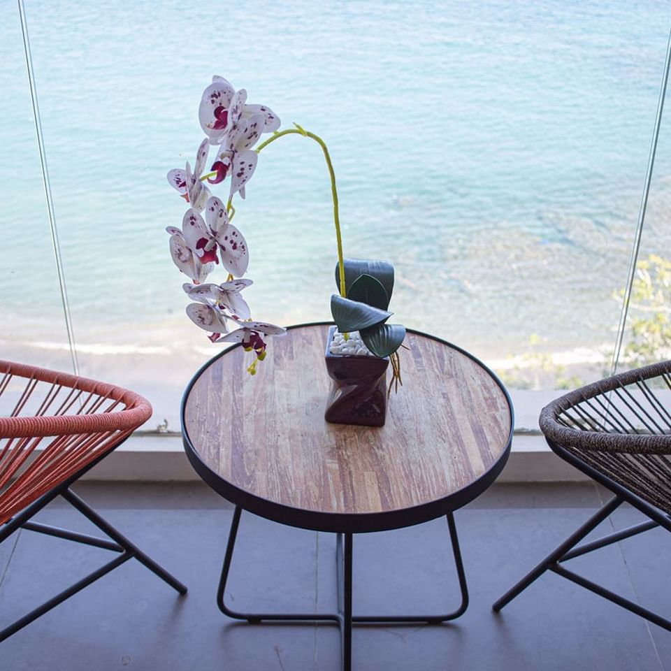 Sea view from an upstairs balcony with loungers at LK Resort Senggigi Lombok