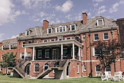 Exterior view of Spencer Hotel & Conference Centre with its white columned patio & stairs, one of the historic hotels Ontario