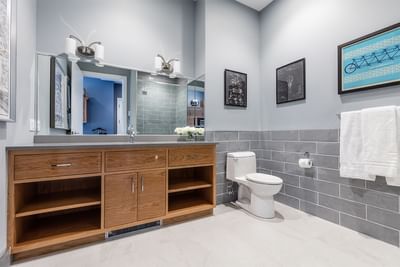 Double bathroom vanity, mirror, fresh flowers & towel rack in King Premiere Academic in Retro Suites Hotel