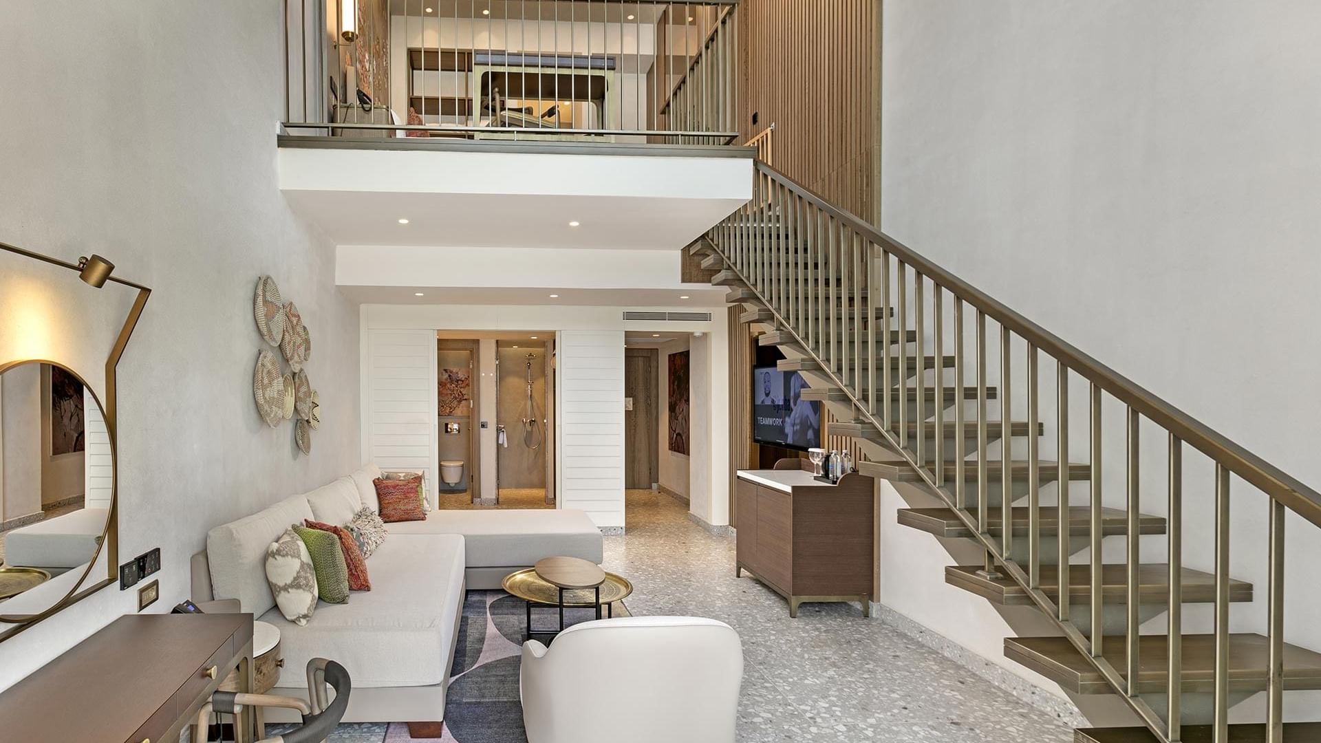 TV lounge area with staircase in Family Duplex Room at Cullinan Belek