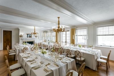 Set up long tables with candles & floral arrangements in Willow Room at Spencer Hotel, best restaurants in London Ontario