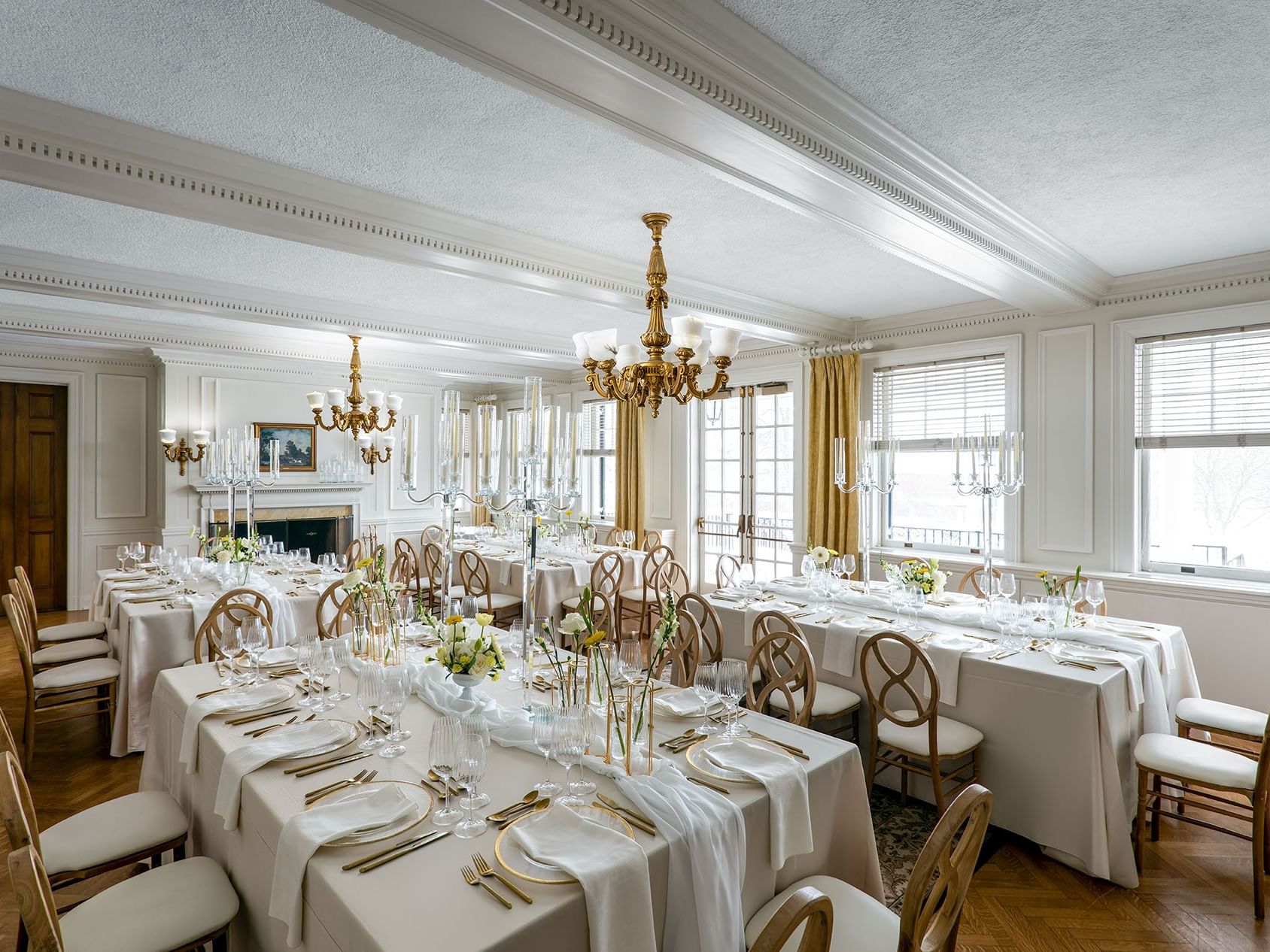 Set up long tables with candles & floral arrangements in Willow Room at Spencer Hotel, best restaurants in London Ontario