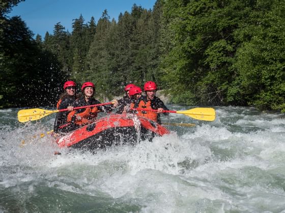 Group of people doing whitewater rafting near Adara Hotel