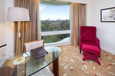 Red comfort chair and park view room at Royal on the Park hotel