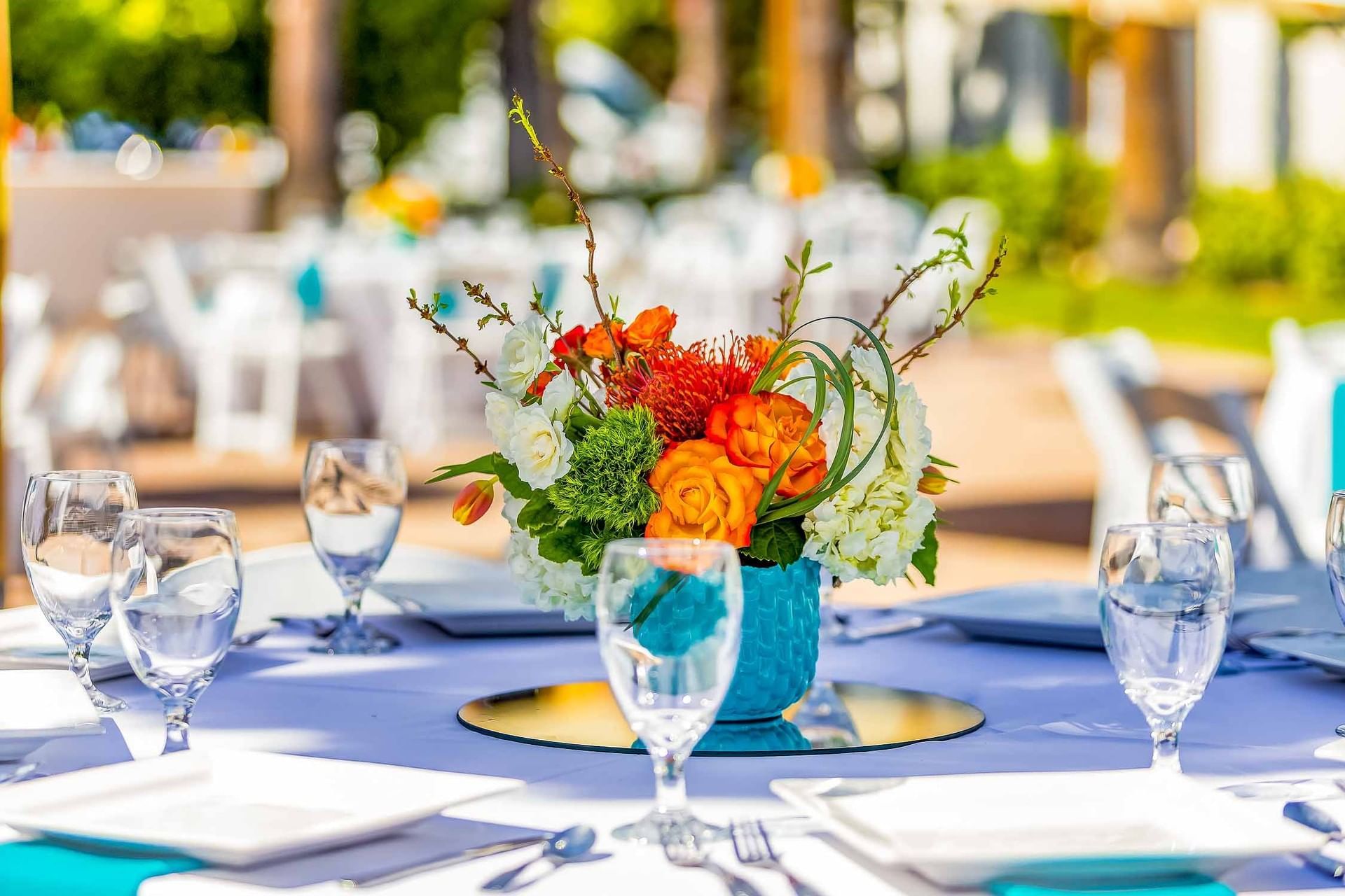 A dining table set with flowers and wine glasses