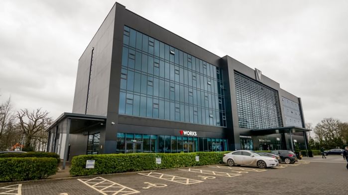 An exterior view of the hotel & car park at Village Hotels