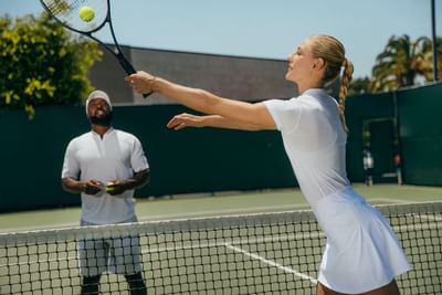 A woman training tennis at Luxe Sunset Boulevard