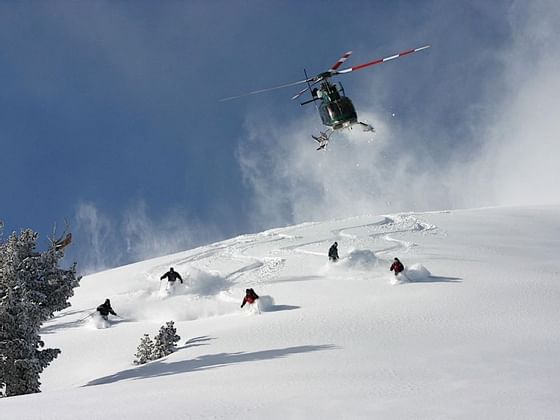 Heli skiing at the hills covered with snow near Hotel Jackson