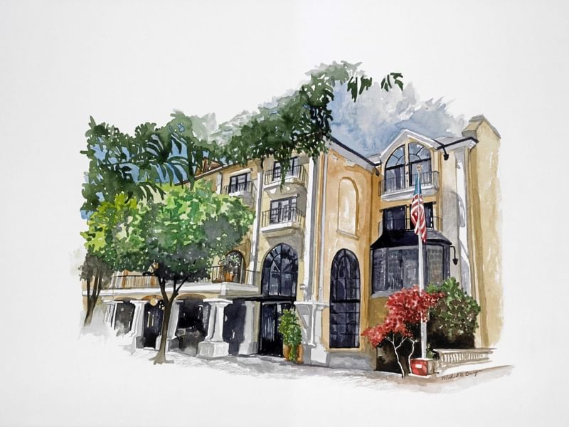 A vibrant watercolor painting of the charming El Prado Hotel exterior, featuring lush trees and an American flag