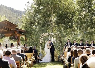 Bride & groom posing by the aisle at Stein Eriksen Lodge