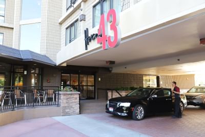 A car parked near the hotel entrance at hotel 43