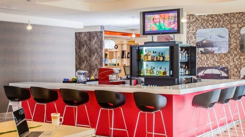 Bar counter with bar chairs in la Isla at Fiesta Inn Hotels