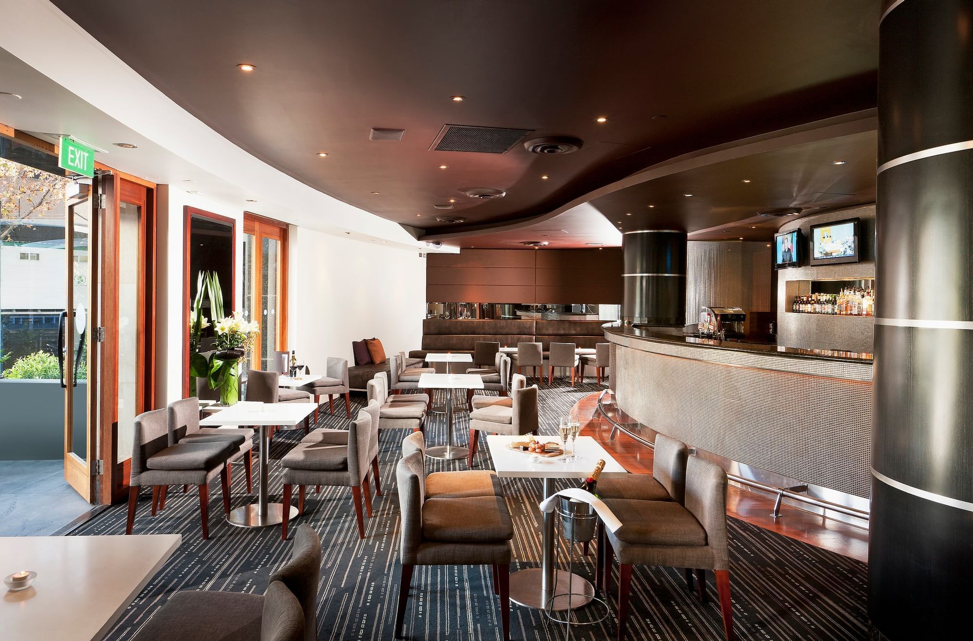 Dining tables arranged in Jarrah Bar & Terrace at Quay West Suites Melbourne