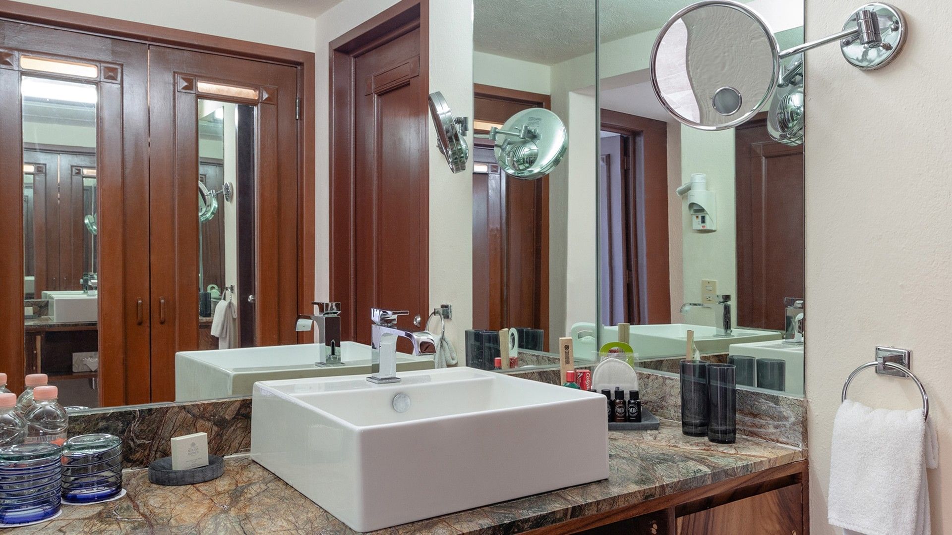 Bathroom vanity with a square white sink and dark marble countertops in King Master Suite at Camino Real Acapulco Diamante