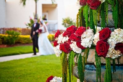 Photo of roses with newlyweds in the background.