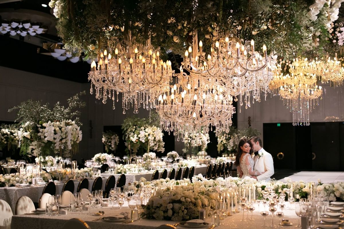 A wedded couple posing in a ballroom at Crown Hotel Perth