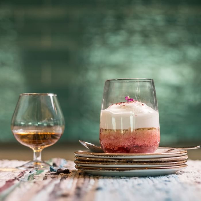 Closeup of cake jar & wine glass on a table at Novotel Barossa